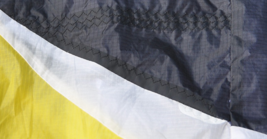 closeup of a repaired paraglider stitched internally